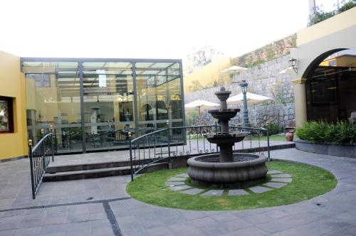 a fountain in a courtyard in front of a building at El Cabildo Hotel in Arequipa