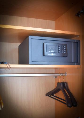 a microwave oven on a shelf in a kitchen at Boutique Hotel Villa Sarah in Düsseldorf