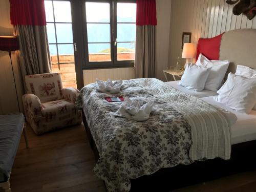 a hotel room with a bed with towels on it at Hamilton Lodge & Spa in Belalp