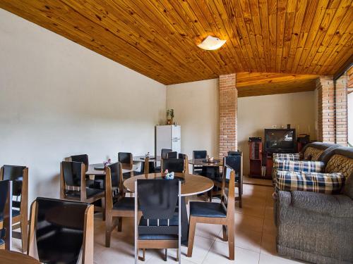 a dining room with a table and chairs at Pousada Recanto São Benedito in Campos do Jordão