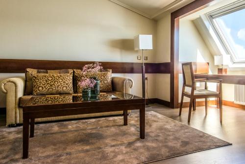 a living room with a couch and a table at Eurostars Louxo Talaso in Isla de la Toja