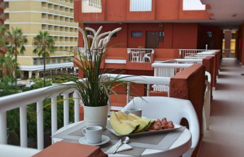 einen Teller mit Essen auf einem Tisch auf einem Balkon in der Unterkunft Edificio Seguro de Sol, Puerto La Cruz, Islas Canarias Tenerife in Puerto de la Cruz