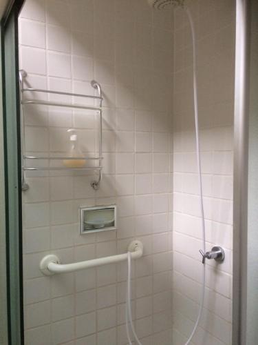 a bathroom with a shower with a glass door at Comodita in São Paulo