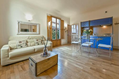 a living room with a couch and a table at Palazzo Uguccioni Apartments in Florence