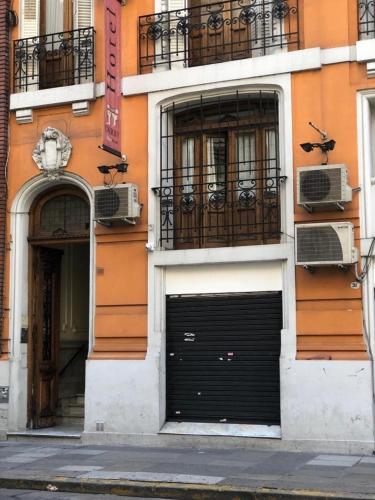 a building with two garage doors on the side of it at Derby Home Hotel in Buenos Aires