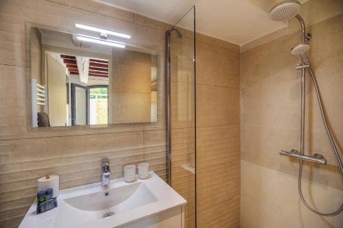 a bathroom with a sink and a shower at Le Refuge - Gigaro Lodges in La Croix-Valmer