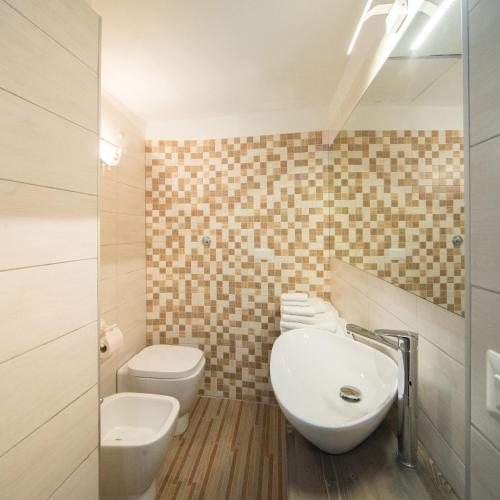 a bathroom with a sink and a toilet at Palazzo RICCA GUARDUCCI 2 in Montefiascone