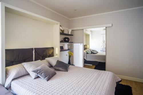 a bedroom with a white bed with pillows on it at Palazzo RICCA GUARDUCCI 2 in Montefiascone
