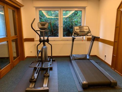a gym with two tread machines and a window at Hotel-Restaurant Goldenstedt in Delmenhorst