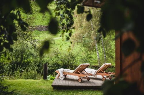 a couple of lounge chairs sitting on a deck at Guesthouse St Nikolaus in Ultimo
