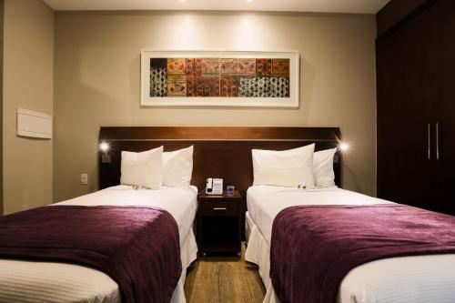 Katil atau katil-katil dalam bilik di San Diego Suites Ipatinga