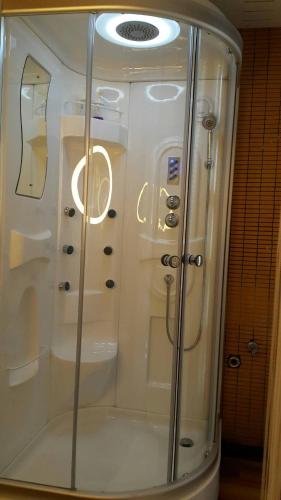 a glass shower in a bathroom in a room at Bed in Town in Chiang Mai