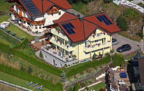 a large house with solar panels on its roof at Haus Heigl in Sankt Johann im Pongau