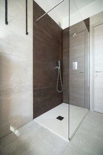 a bathroom with a shower with a glass door at LA VALIGIA Bed & Bike - Gateway to Valtellina & Lake Como in Mantello