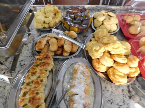 a bunch of different types of food on a counter at Hotel Real São Lourenço in São Lourenço