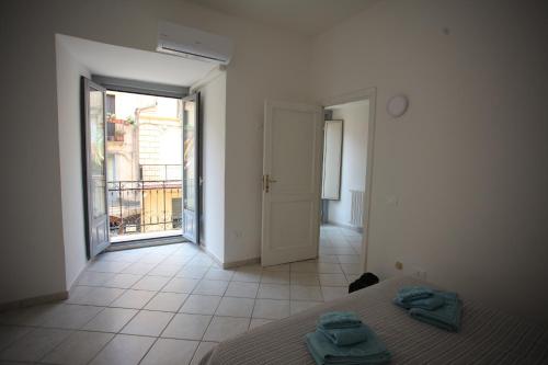 a bedroom with a bed with two towels on it at Corso Garibaldi 22 apartment in Paola