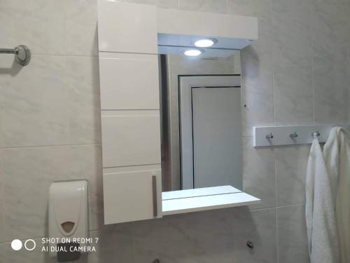 a bathroom with a mirror and a sink at Blue Marine Ap 26 in Ravda