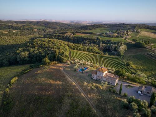 an aerial view of a vineyard and a house in a field at Castello di Bossi in Castelnuovo Berardenga