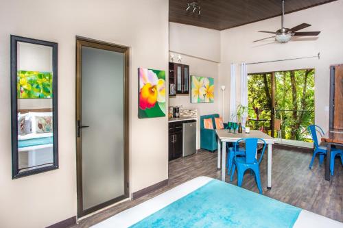 a kitchen and dining room with a table and chairs at Tico Tico Villas - Adult Only in Manuel Antonio