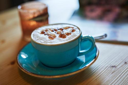a blue cup of coffee on a table at Hotel Gasthof zur Post in Winterberg
