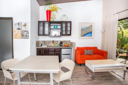 a living room with a table and a couch at Tico Tico Villas - Adult Only in Manuel Antonio