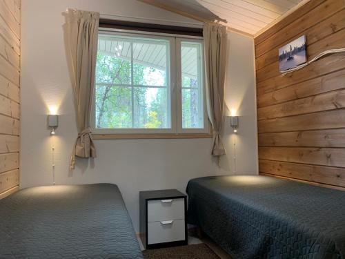 Un pat sau paturi într-o cameră la Villa Haukka