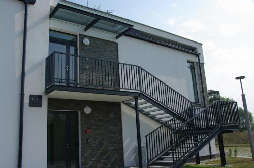 a house with a staircase on the side of it at Rayo del Sol Łukęcin in Łukęcin