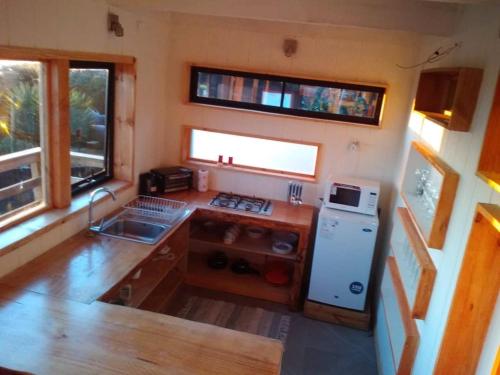 an aerial view of a kitchen in a tiny house at Loft Playa Puertecillo, mar y sunset increíble in Puertecillo