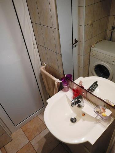 a bathroom with a sink and a washing machine at SEASIDE VACATION RENTAL 4TUNA in Krk