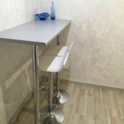 a white table with a stool and a white counter at Grenaa Bed and Breakfast in Grenå