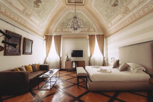 a living room with a large bed and a couch at Al Palazzetto in Tivoli
