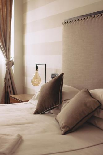 a bed with two pillows on it in a bedroom at Al Palazzetto in Tivoli
