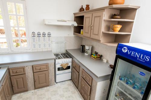 a kitchen with wooden cabinets and a fish tank at Maison entière ChezSoa, antananarivo in Andoharanofotsy