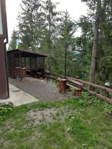 a wooden bench sitting next to a wooden fence at Біла хата in Iltsi