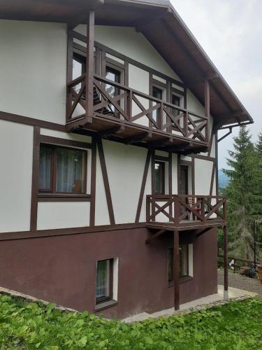 a building with a balcony on the side of it at Біла хата in Iltsi