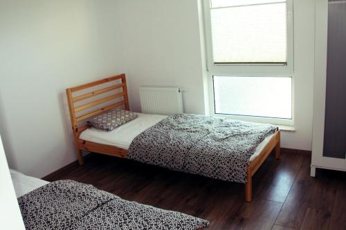 Posteľ alebo postele v izbe v ubytovaní Apartament Spacerowa