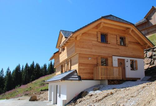 a wooden house on top of a pile of dirt at Berghütte Murmele in Lachtal