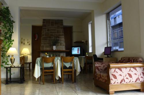 a living room with a table and chairs and a fireplace at Apolo Atlantis in Mar del Plata