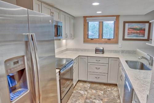 a kitchen with a stainless steel refrigerator and a sink at Lances West 6 in Breckenridge