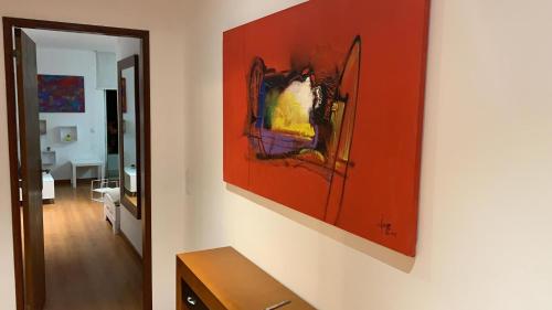 a painting hanging on a wall in a room at House BLZ in Charneca