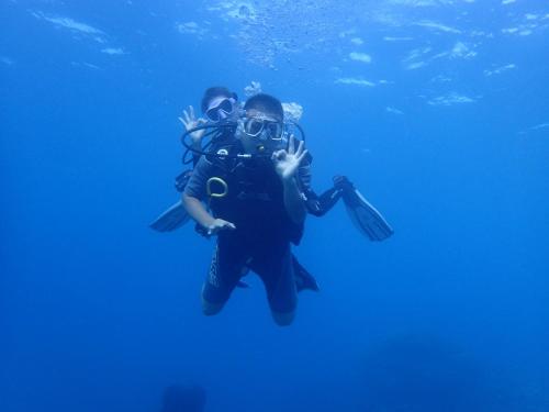 two people are swimming in the water at Xen Midu Hotel Addu City Maldives in Midu