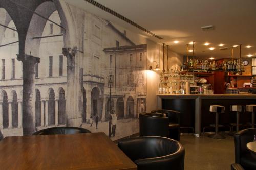 a restaurant with a mural on the wall at Hotel Europa in Viadana