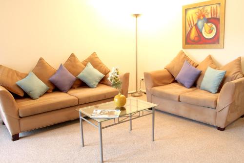 a living room with two couches and a coffee table at Tresori Motor Lodge in Akaroa