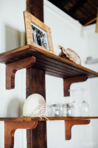 a wooden shelf with a book and a ball on it at Aore Island Resort in Luganville
