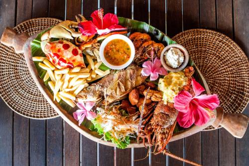 a large plate of food on a wooden table at Aore Island Resort in Luganville