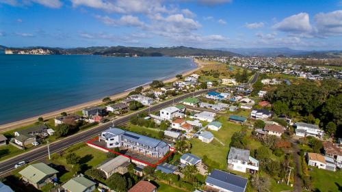 an aerial view of a town next to a beach at Bayside Motel Whitianga in Whitianga
