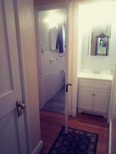 a bathroom with a sink and a door with a mirror at Sleepy Hollow Manor in Gettysburg