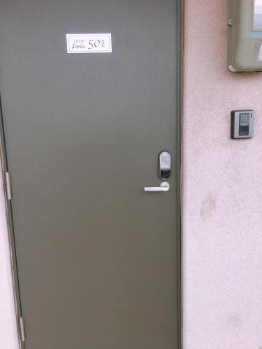 a door with a sign that reads take the son at Little Santa in Ginowan