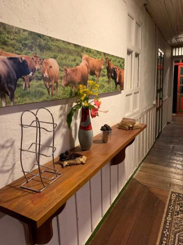 a room with a counter with cows on the wall at Ecohotel Pinohermoso Reserva Natural in Salento