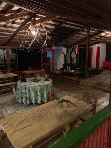 a large room with a table and benches in it at Ecohotel Pinohermoso Reserva Natural in Salento